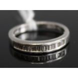 A platinum and small baguette diamond channel set half eternity ring, 4.2g, size J