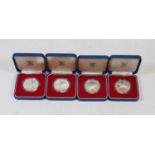 An Elizabeth II 1977 silver proof crown, boxed; together with three other similar examples (4)