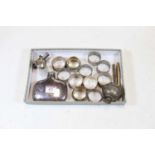 A collection of miscellaneous items to include various silver and silver plated napkin rings, engine