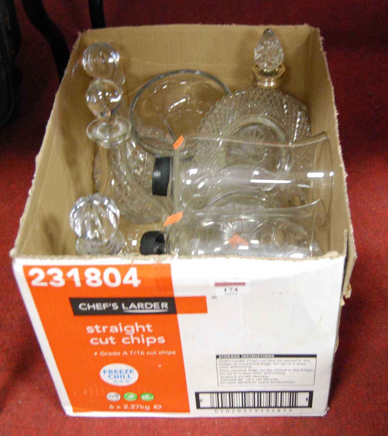 A box containing a collection of cut and pressed glassware to include decanters