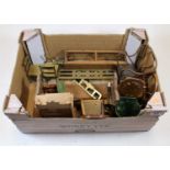 A box of miscellaneous dolls house furniture to include wicker open armchair, brass fender, brass