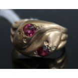 A 9ct gold snake ring, each snake head set with a single round cut garnet (worn), 3.7g, size O/P