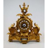 A 19th century French gilt metal mantel clock, the dial with raised enamel Roman numeral cartouches,