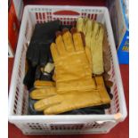 A box containing a collection of various vintage leather gloves