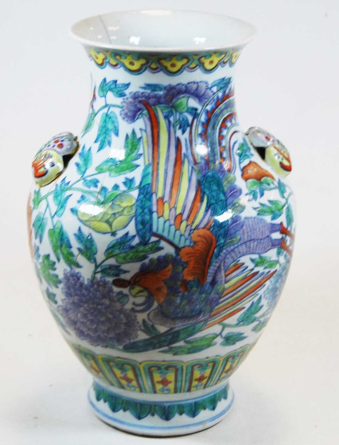 A Chinese export vase of baluster form with applied butterfly handles, decorated with flora and