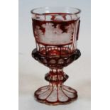 A 19th century Bohemian overlaid and wheel engraved goblet decorated with figure landscape scene,