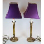 A pair of 20th century brushed brass table lamps, each with purple shade