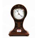 An early 20th century inlaid mahogany cased balloon mantel clock, the circular dial having Arabic