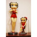A 20th century plaster figure of Betty Boop in standing pose on circular plinth, height 86cm,