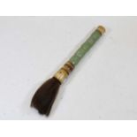 A calligraphy brush, having sectional carved jadeite handle, length 26cm (excluding bristles)