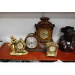 A 1930s oak cased mantel clock, the silvered dial showing Arabic numerals together with three