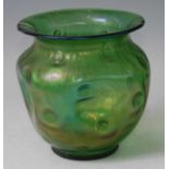 A possibly Loetz early 20th century green glass vase, the everted rim over pinched body, with