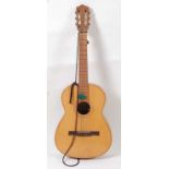 A Tranquillo Giannini Brazillian nylon strung acoustic guitar, the shaped headstock with ivornene