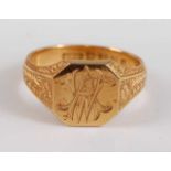 An 18ct yellow gold octagonal signet ring, with interlinking initials AW and shoulders engraved with