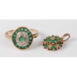 A 9ct gold emerald set dress ring, arranged as a centre oval cut emerald in a rubover setting,