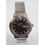 A Gents stainless steel Omega Mega-Quartz wristwatch, with round black baton dial and day/date at