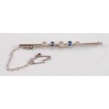 A white metal early 20th century sapphire and diamond bar brooch, featuring two oval faceted