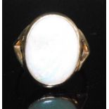 A 9ct yellow gold opal dress ring, comprising a white opal cabochon in a bezel setting, with