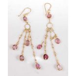 A pair of yellow metal multi-strand tourmaline drop earrings, each with five oval faceted