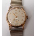 A yellow metal Record manual wind wristwatch, having round cream Arabic dial with subsidiary dial at