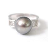 An 18ct white gold, pearl and diamond dress ring, featuring a 10.25mm Tahitian cultured pearl