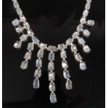 A white metal moonstone fringe necklet, comprising 70 oval moonstone cabochons in claw settings,