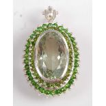 A sterling silver prasiolite and diopside oval cluster pendant, the prasiolite measuring approx 23.2