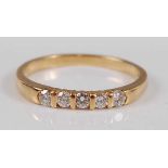 An 18ct yellow gold diamond five stone half hoop eternity ring, comprising five round brilliant