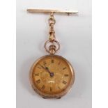 A 9ct yellow gold lady's manual wind open faced fob watch, with gilded Roman dial and engraved