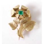 A yellow metal brooch in the form of a three-dimensional flower, with engraved detail and an