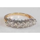 An 18ct yellow and white gold diamond seven-stone half hoop eternity ring, featuring seven round