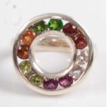 A white metal circular multi-stone ring, comprising two chrome diopside, two garnets, two rock