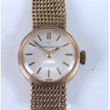 A 9ct yellow gold lady's Eternamatic wristwatch, having round silver baton dial and integral