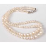 A cultured pearl double strand choker, the white metal clasp having five graduated pavé set old