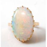 An 18ct yellow gold oval opal dress ring, the cabochon cut opal measuring approx 20.2 x 13.0 x 3.