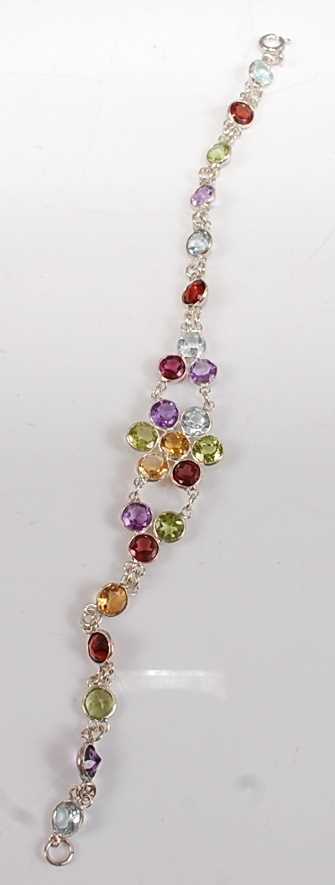 A white metal flower design multi-stone bracelet, having 6 round garnets, 5 round peridots, 5 - Image 2 of 3