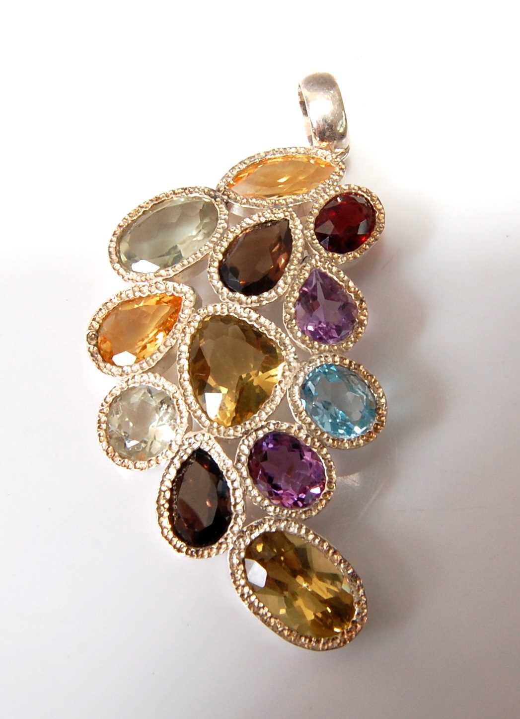 A sterling silver abstract pendant, comprising two citrine, two lemon quartz, two prasiolite, two