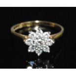 An 18ct yellow and white metal diamond circular cluster ring, comprising nine round brilliant cut