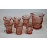 An early 20th century pink tinted moulded glass lemonade set, comprising jug and six matching