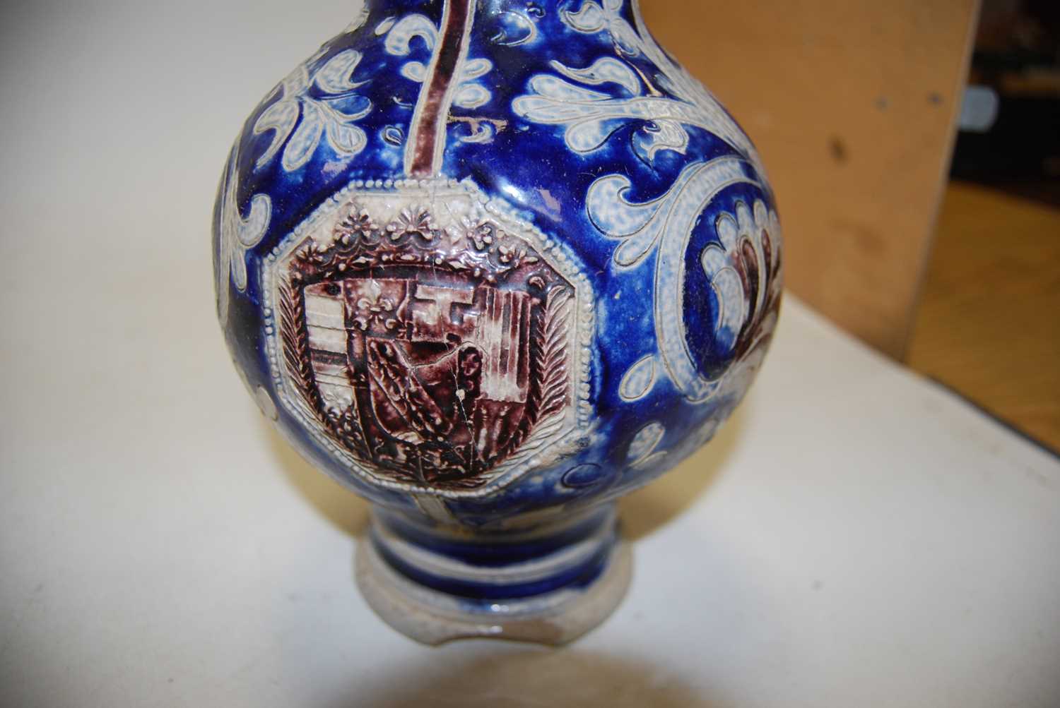 A German Westerwald stoneware jug, with pewter lid and thumb rest decorated in blue with a crucifix, - Image 12 of 14