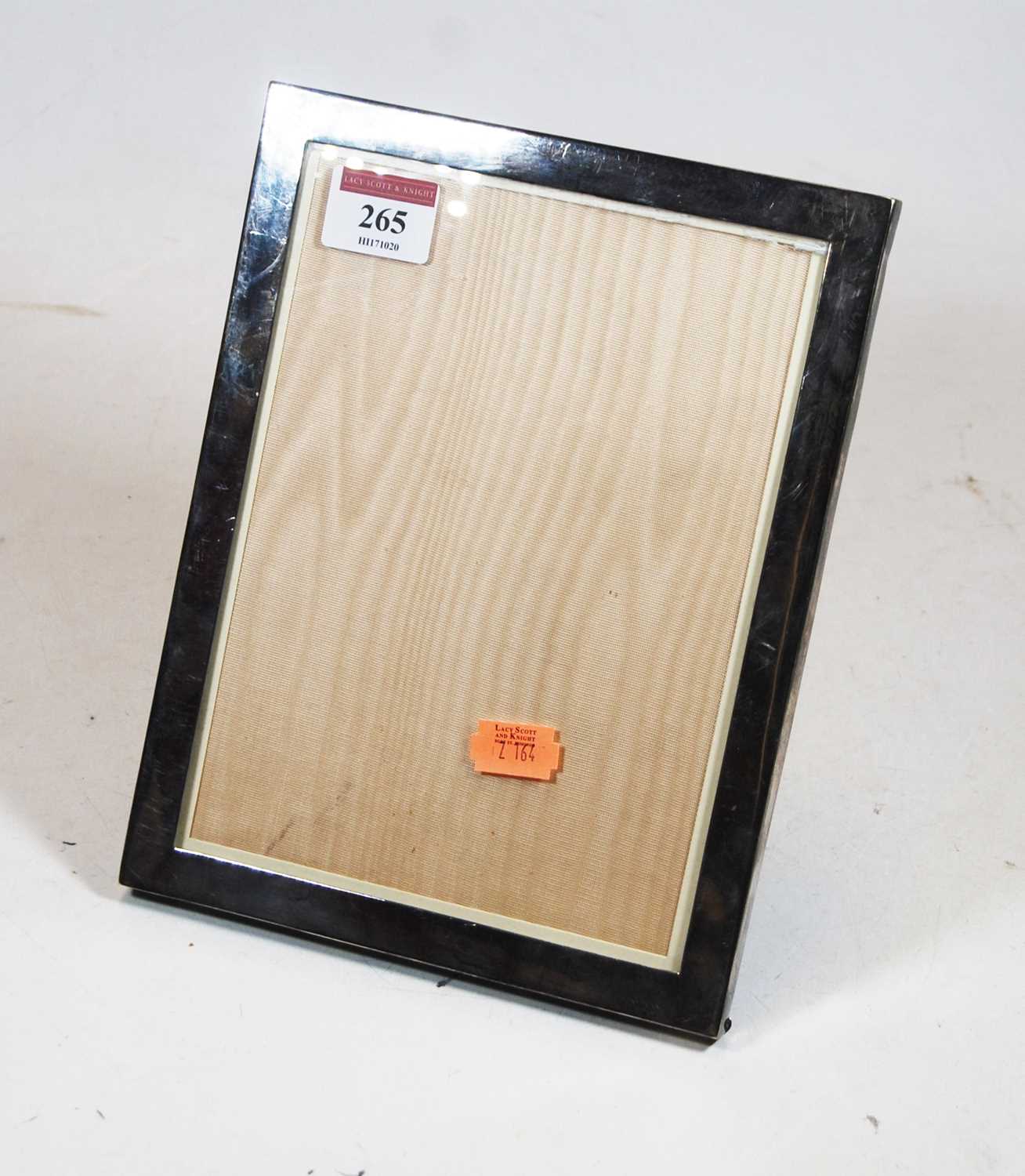 A modern silver clad easel photograph frame, of plain rectangular form, 23 x 18cm