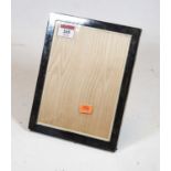 A modern silver clad easel photograph frame, of plain rectangular form, 23 x 18cm