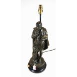 A 20th century cast metal table lamp in the form of Shakespeare in standing pose, on circular plinth