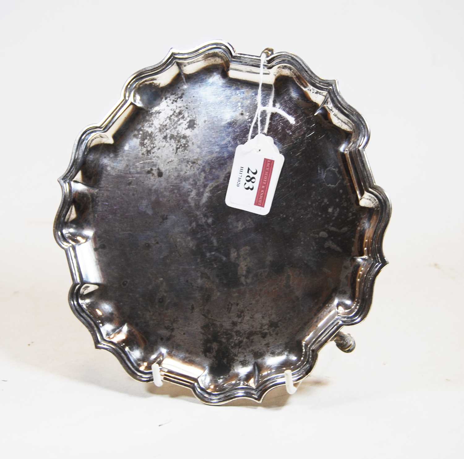 An Edwardian silver card waiter, of shaped rectangular form, having raised piecrust rim and