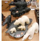 A polished serpentine marble model of a polar bear, together with three other similar models of