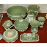 A collection of Wedgwood green jasper ware to include a small water jug, a pin tray, spill vase,