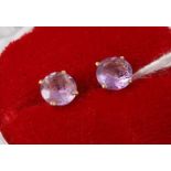 A pair of yellow metal and amethyst set ear studs, each stamped 750, amethyst dia.6.5mm
