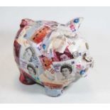 A 20th century ceramic piggy bank, with 10p pieces for eyes and 5p pieces for nostrils, height 24cm