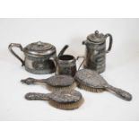 Three various circa 1900 silver backed brushes; together with a Walker & Hall silver plated three-