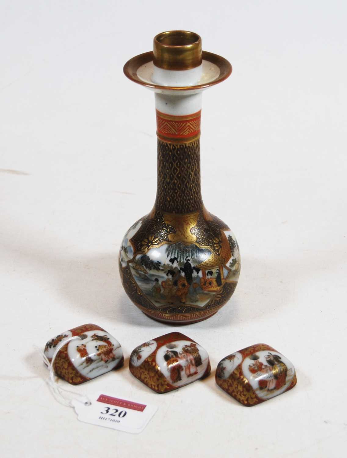 A Japanese Meiji period kutani candlestick having slender neck to bulbous lower body decorated